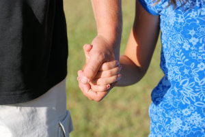 parent and child holding hands